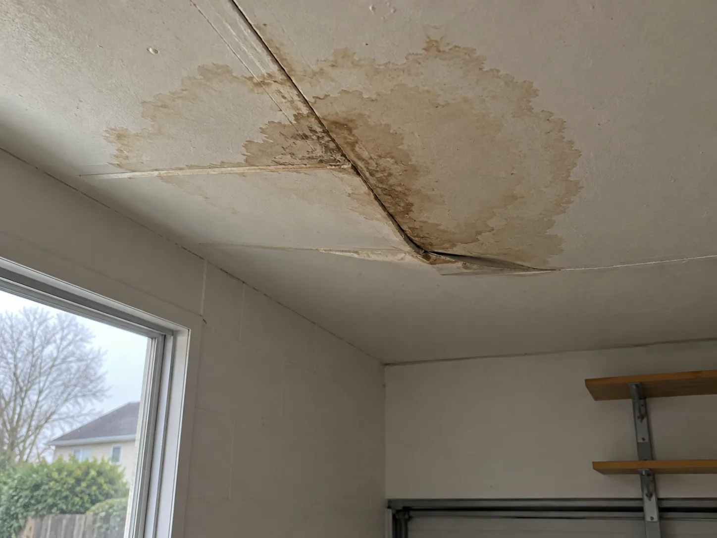 Water damaged ceiling board in a Dallas garage